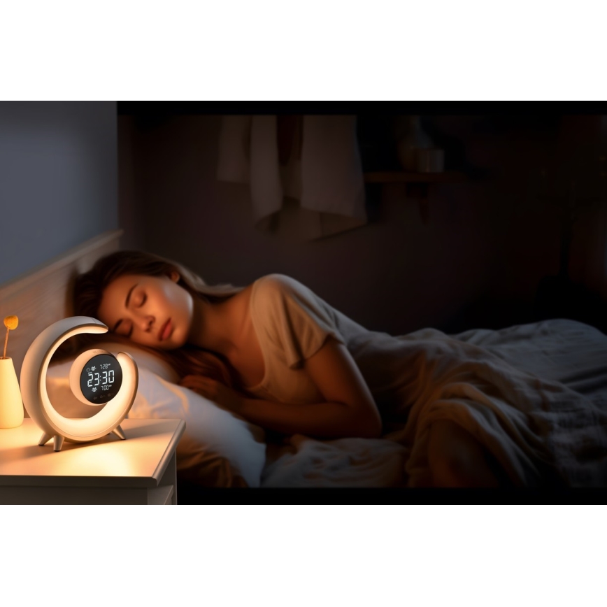 LED RGBW himmennettävä pöytävalaisin herätyskellolla PEACOCK LED/20W/5V USB