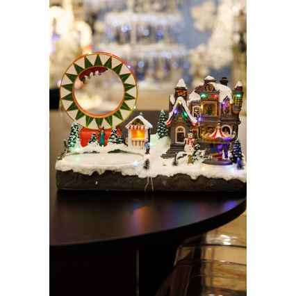 LED RGB Animoituja joulukoristeita musiikin kera 30xLED/1,5W/230V luminen kylä