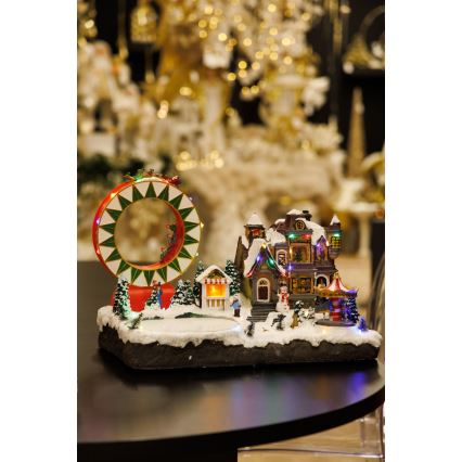 LED RGB Animoituja joulukoristeita musiikin kera 30xLED/1,5W/230V luminen kylä