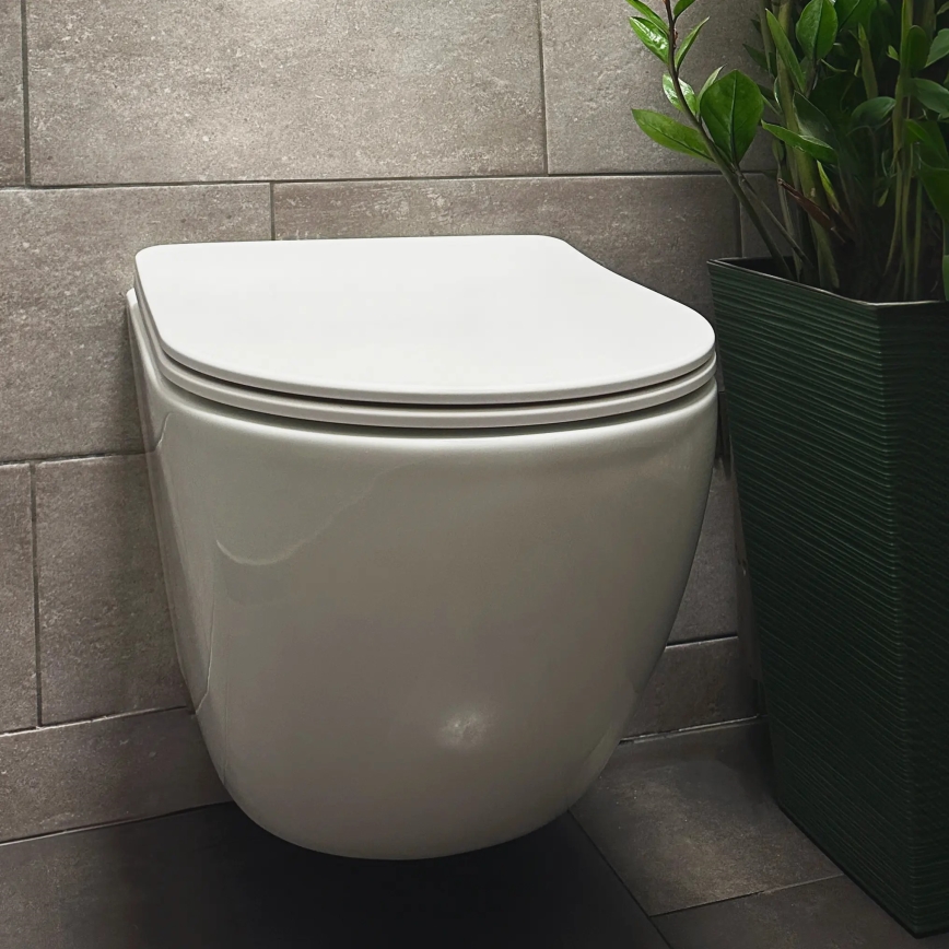 REA-C1259 - Seinään kiinnitettävä WC-istuin istuinkannella CARLO MINI TORNADO RIMLESS, keraaminen/kiiltävän valkoinen
